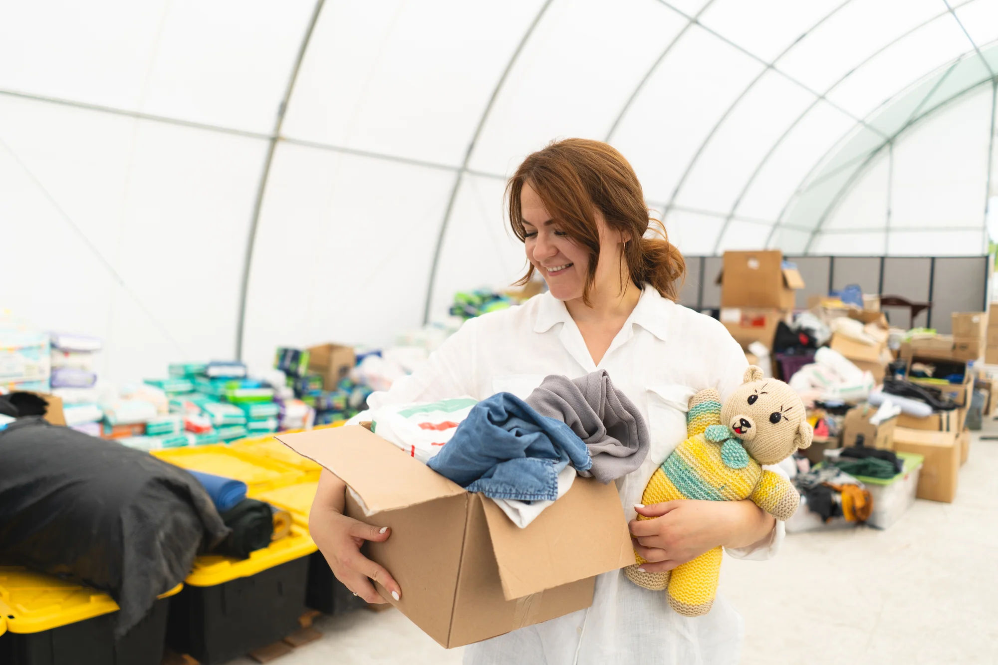 volunteer-woman-preparing-donation-boxes-for-peopl-2025-03-09-15-40-29-utc